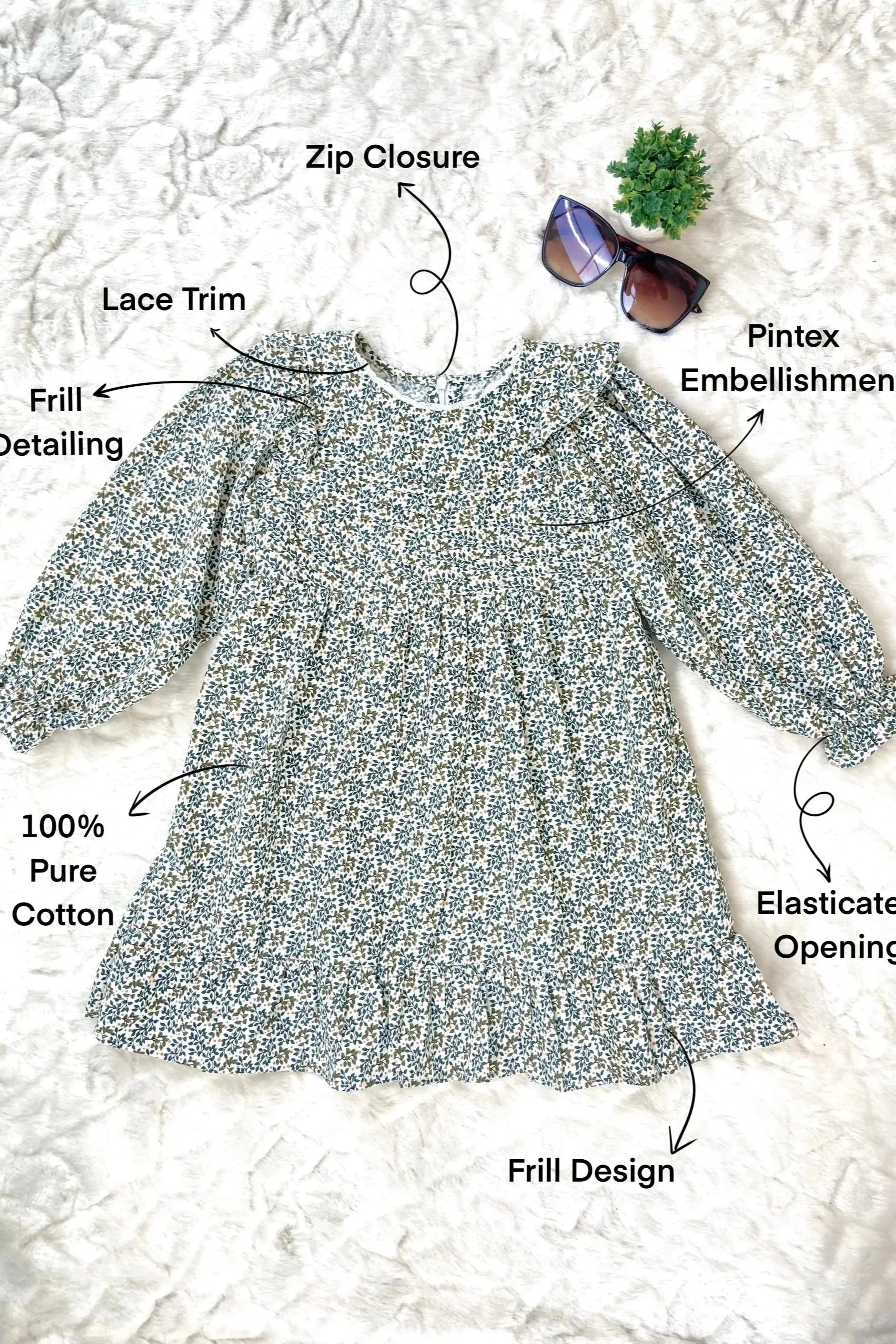 Flat image of a green dress for baby girl, designed for kids aged 2 to 9 years old.