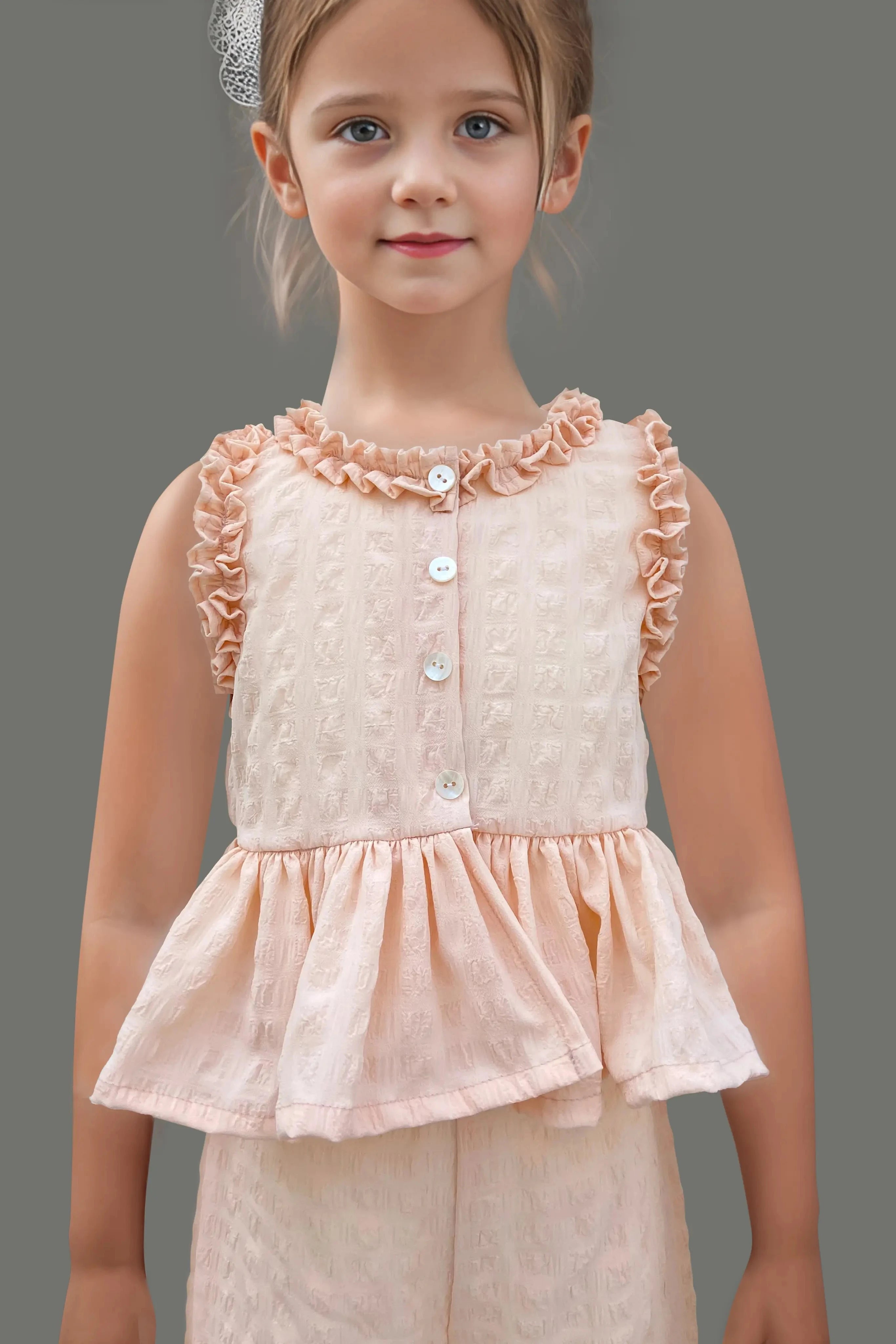 Front close up of a Peach Ruffled Top and Pant Set for Kids.