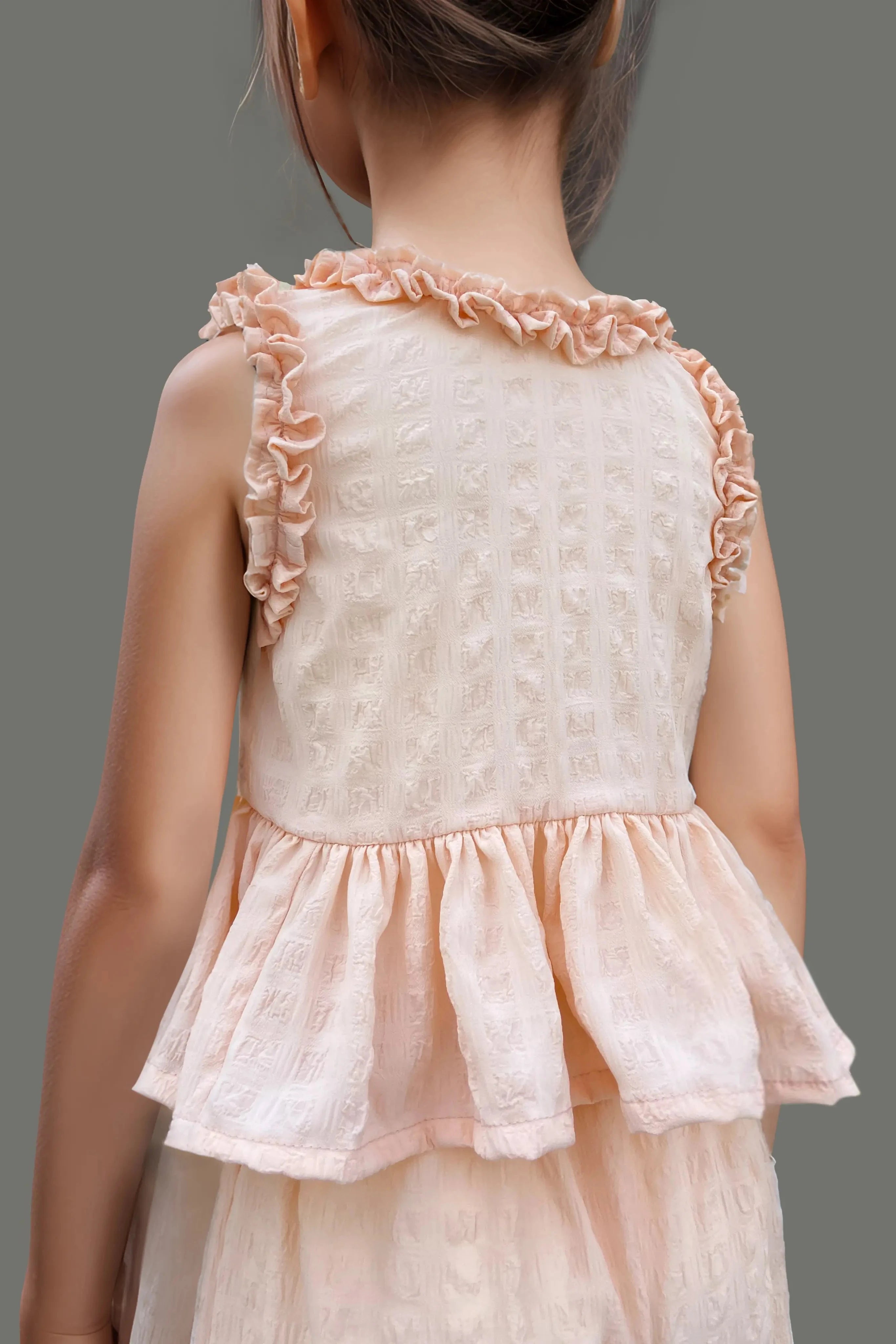 Back close up of a Peach Ruffled Top and Pant Set for Kids.